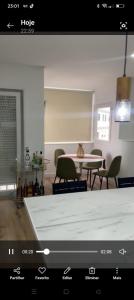 a view of a living room with a table and chairs at Apartamento T3 remodelado in Barcelos