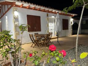 a patio with a table and chairs and an umbrella at Ca La Lola in Llorenç del Penedes