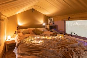 a bedroom with a large bed in a tent at Camping Le Val de Cesse in Mirepeisset +180 photos