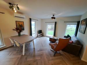 a living room with a table and a couch at Erve Lindehof in Lochem