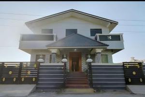 a house with a gate in front of it at Vintage Luxury Bungalow in Puducherry