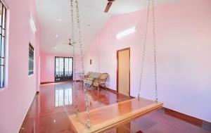 a living room with a swing in a house at Vintage Luxury Bungalow in Puducherry