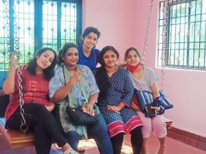 a group of women sitting on a swing at Vintage Luxury Bungalow in Puducherry +1 photo