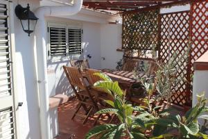 un patio con 2 sillas y una mesa en un porche en B&B Le Terrazze, en Crotone