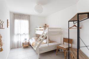 a bedroom with a bunk bed with a ladder at La Belle de Fréhel - Jolie maison avec jardin in Frehel