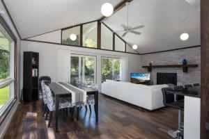 a living room with a table and a couch at Bass Lake Retreat in Pisgah Forest