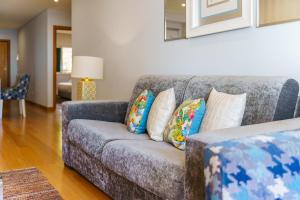 カニコにあるGuestReady - Ocean-View Retreat in Caniçoのリビングルーム(枕付きのグレーのソファ付)