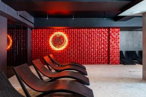 a group of chairs in front of a red wall at Gold Palace SPA Resort Bukovel in Bukovel +121 photos