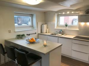 a kitchen with a table with a bowl of fruit on it at Leilighet i sentrum i Frederikshavn - Grete in Frederikshavn
