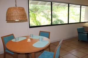 a dining room with a wooden table and chairs at Private Resort Suite, Hotel Amenities & Golf in Las Lajas +3 photos