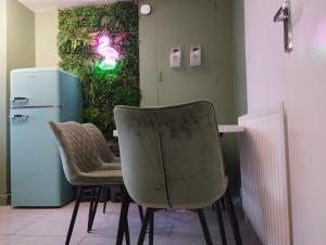 a room with a table and two chairs and a refrigerator at Brighton Central Accommodation in Brighton & Hove