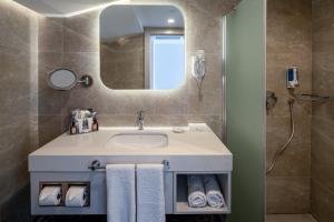 a bathroom with a sink and a mirror at Swandor Hotels & Resorts - Kemer in Kemer