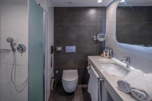 a bathroom with a sink and a toilet and a shower at Swandor Hotels & Resorts - Kemer in Kemer