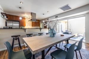 a kitchen and dining room with a wooden table and chairs at Scottsdale Orange Blossom in Scottsdale