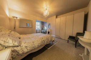 a bedroom with a bed and a sink and a mirror at 107a - 3 Double Bedrooms in Lytham St Annes