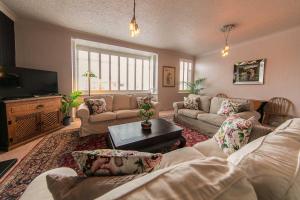 a living room with couches and a flat screen tv at 107a - 3 Double Bedrooms in Lytham St Annes