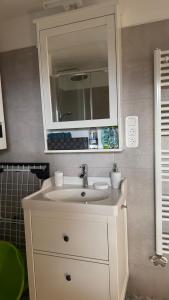 a bathroom with a white sink and a mirror at Red Stone Apartman Kővágóörs Pálköve 200m a Balaton parttól kilátással in Kővágóörs +60 photos