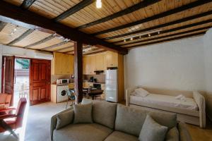 a living room with a couch and a kitchen at Rustic Elegance in Omodos in Omodos