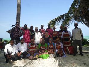 a group of people posing for a picture on the beach at Paradise Beach Bungalows in Paje