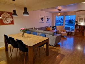 a living room with a table and a couch at Granåsen World Championship Stay Walk to Ski Arena in Trondheim