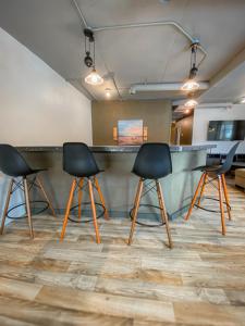 a meeting room with three chairs and a bar at Ingalls Flat in De Smet