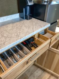 a kitchen counter with wooden drawers filled with wine bottles at Ingalls Flat in De Smet