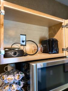 a kitchen with a microwave and some dishes on a shelf at Ingalls Flat in De Smet +32 photos