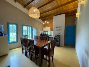 a kitchen and dining room with a wooden table and chairs at Casa en el Quebrachito in Formosa