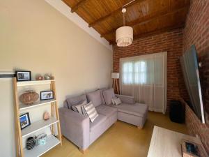 a living room with a couch and a tv at Casa en el Quebrachito in Formosa
