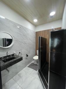 a bathroom with a sink and a toilet and a mirror at Casa en el Quebrachito in Formosa +53 photos