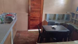Una pequeña cocina con una mesa y un fregadero. en The Roaming Nest - Panglao, en Panglao