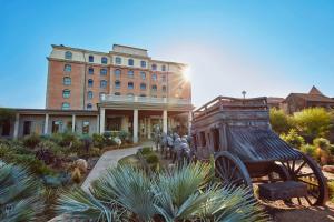 una estatua de un carruaje tirado por caballos frente a un edificio en PortAventura Hotel Gold River - Includes unlimited access to PortAventura Park & 1 access to Ferrari Land, en Salou