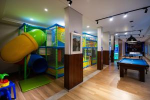 a play room with a slide and a pool table at Tarobá Hotel in Foz do Iguaçu