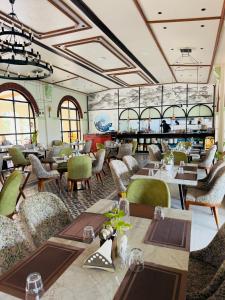 a restaurant with tables and chairs and a bar at Jaladarshini Lakeside Gardens in Kollam