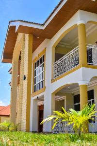 a house with a balcony on the side of it at THE AFRICAN PALACE- Free Airport Pick up - High Speed Starlink WiFi - Car Rental in Tamale +28 photos
