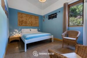 a bedroom with a bed in a blue room at Villa Luisa in Torre delle Stelle +92 photos
