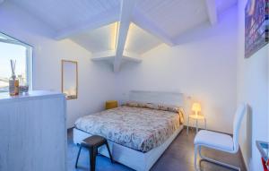 a white bedroom with a bed and a chair at Cozy Apartment In Tortoreto Lido in Tortoreto Lido +21 photos