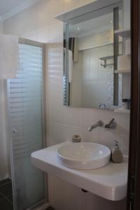 a bathroom with a white sink and a mirror at Crescent Hasirci Hotel in Dalyan