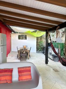 a patio with a table and a couch and a table and a table at Saka Lodge in Le Gosier
