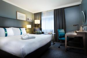 a hotel room with a large bed and a desk at Holiday Inn London - Regent's Park, an IHG Hotel in London