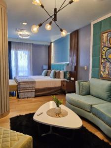 a living room with a bed and a couch at HOTEL KONKE MAR DEL PLATA in Mar del Plata +174 photos