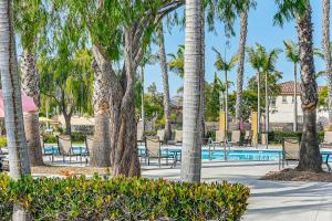 a resort with a pool and palm trees at 20 Mi to Old Town San Diego Stay and Play! in Chula Vista