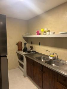 a kitchen with a sink and a counter at Casa estilosa na rua principal de Búzios in Búzios