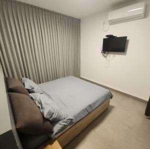 Postel nebo postele na pokoji v ubytování בית אורן - בית דירות - בית שאן