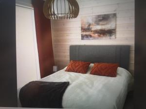 a bedroom with a bed with two pillows on it at Kiiruna Chalet in Kuusamo