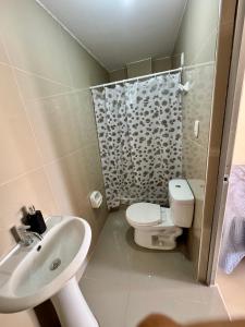 a bathroom with a sink and a toilet and a shower at Habitaciones Chincha in Sunampe