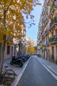 a city street with parked motorcycles and buildings at denis salvà montjuic in Barcelona