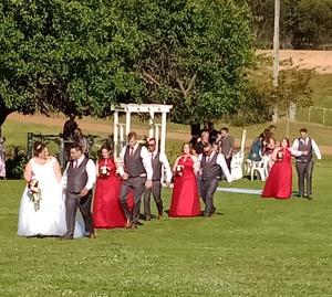 a group of people posing for a picture at a wedding at Redtail Cottages in Hester