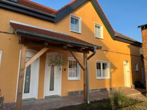a house with an awning on the front of it at Gutshof von Gemünden Ferienwohnung 2 in Bernau bei Berlin