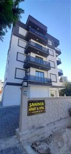 a large building with a sign in front of it at ŞAHİNER APART Otel in Finike +50 photos